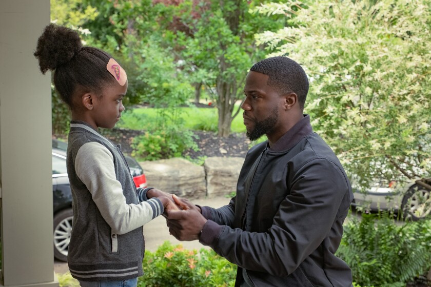 Melody Hurd as Maddy and Kevin Hart as Matt standing outside near two cars in 'Fatherhood.'
