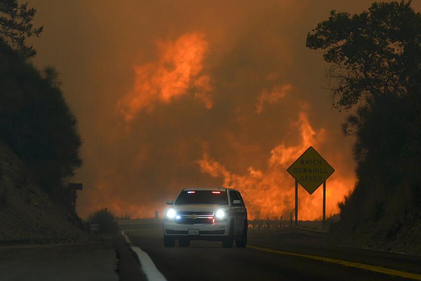 ARCHIVO – El incendio Line arde sobre la autopista 330 mientras un vehículo de emergencia pasa frente a él, el sábado 7 de septiembre de 2024, cerca de Running Springs, California. (AP Foto/Eric Thayer, Archivo)