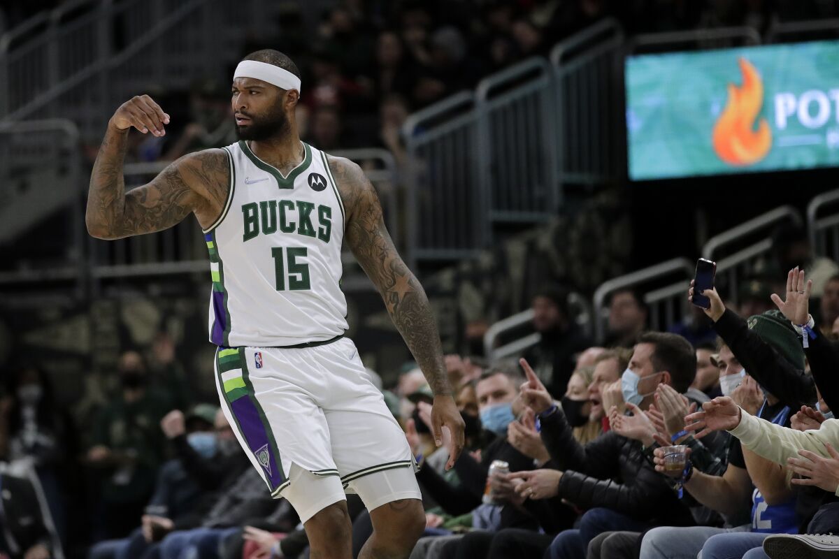 Milwaukee Bucks' DeMarcus Cousins gestures after making a shot during the first half of the team's NBA basketball game against the Toronto Raptors on Wednesday, Jan. 5, 2022, in Milwaukee. (AP Photo/Aaron Gash)