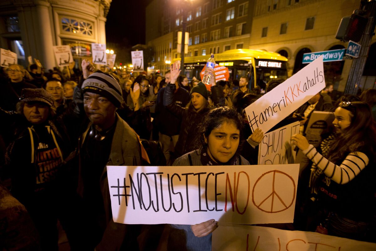 Protesters gather at the intersection of 14th Street and Broadway on Monday, Nov. 24, 2014, in Oakland, Calif., as locals reacted to the decision by a St. Louis County grand jury not to indict Ferguson police officer Darren Wilson in the shooting death of Michael Brown. (D. Ross Cameron/Bay Area News Group/TNS)