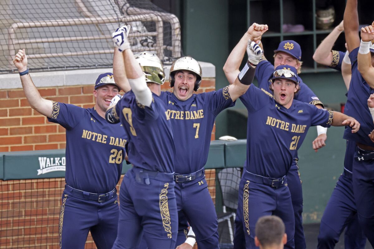 Notre Dame's John Michael Bertrand (28), Jack Zyska (7) and Brady Gumpf (21) celebrate after a home run by Jack Brannigan (9) against Tennessee in the fourth inning during an NCAA college baseball super regional game Friday, June 10, 2022, in Knoxville, Tenn. (AP Photo/Randy Sartin)