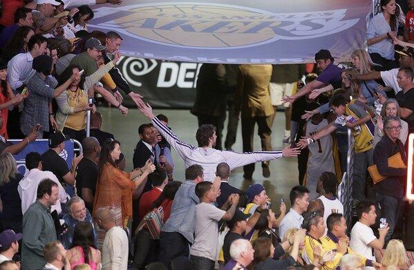 Lakers power forward Pau Gasol reaches out to fans as he leaves the court following a 103-82 loss to the Spurs in Game 4 of their first-round playoff series on Sunday.