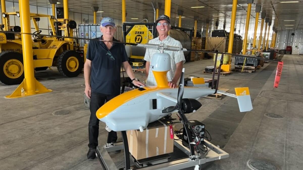 La Jollan Gad Shaanan and Unmanned Aerospace Chief Technology Officer Jeff Knapp stand with the prototype of the GH-4 drone.