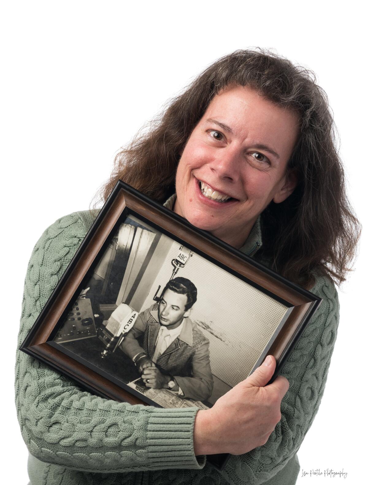 Author Debbie Russell holds a photo of her father, Ralph, as a young man.