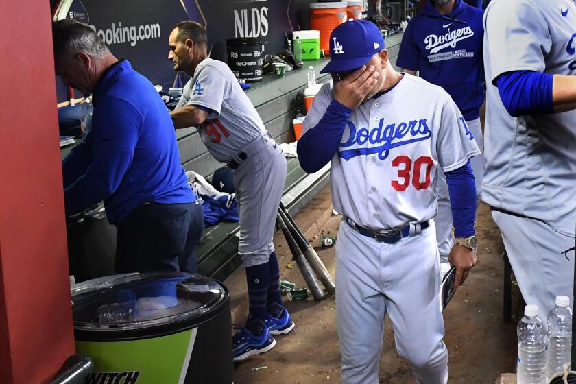 PHOENIX, AZ - October 11: Los Angeles Dodgers manager Dave Roberts reacts to losing.