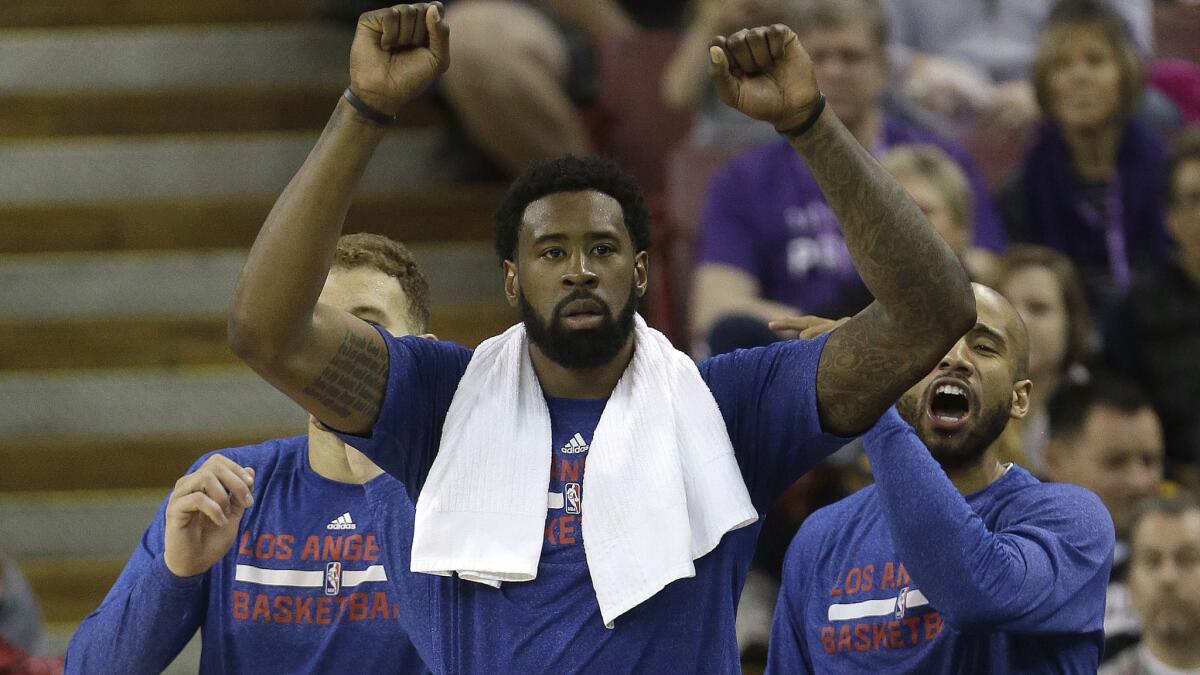 Clippers center DeAndre Jordan celebrates from the sideline after a teammate scores during a win over the Sacramento Kings.
