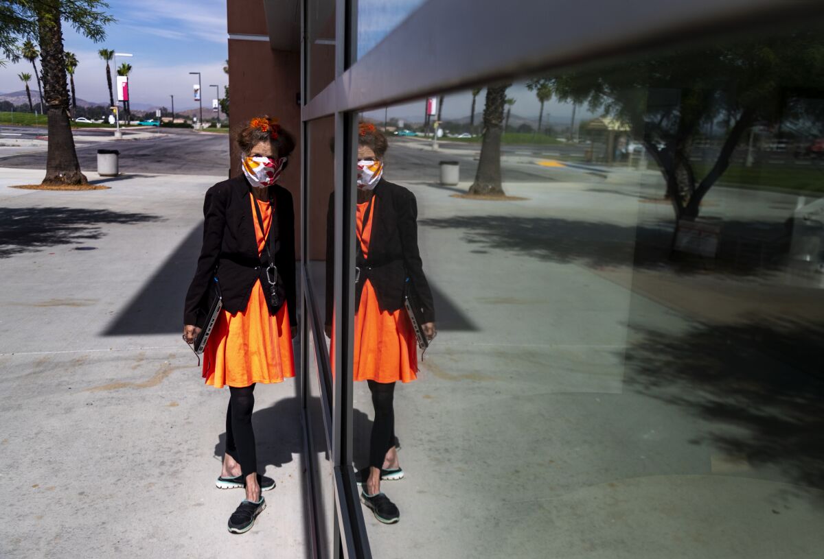 Activist Albia Miller is reflected in the glass at the Mt. San Jacinto College library