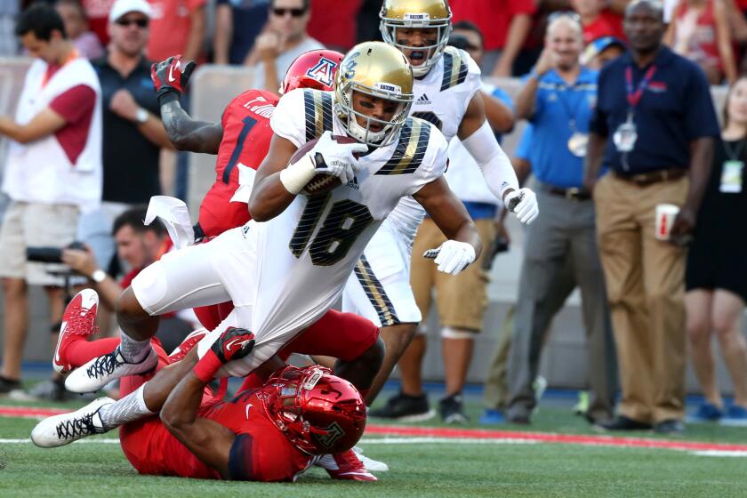 UCLA receiver Thomas Duarte scores a touchdown against Arizona on a 35-yard pass from Josh Rosen in the first quarter Saturday evening in Tucson.