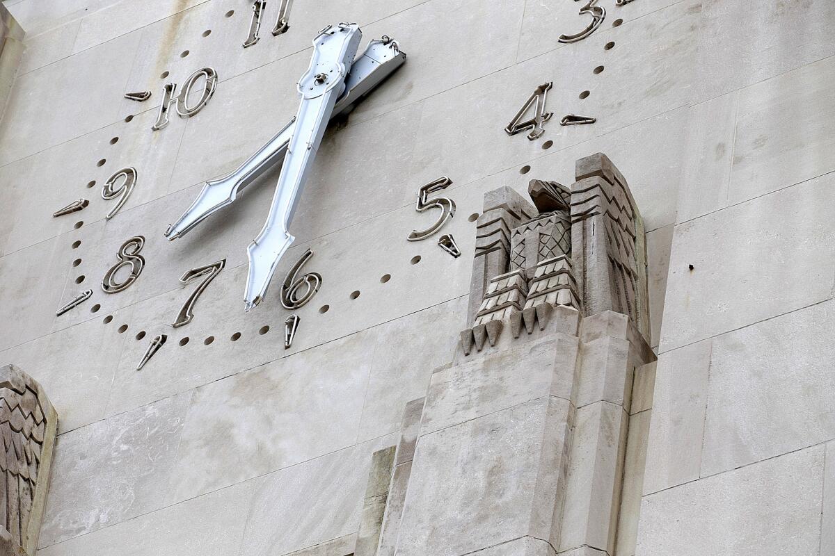 The Gordon B. Kaufmann-designed Times building with clock tower and eagle statues.