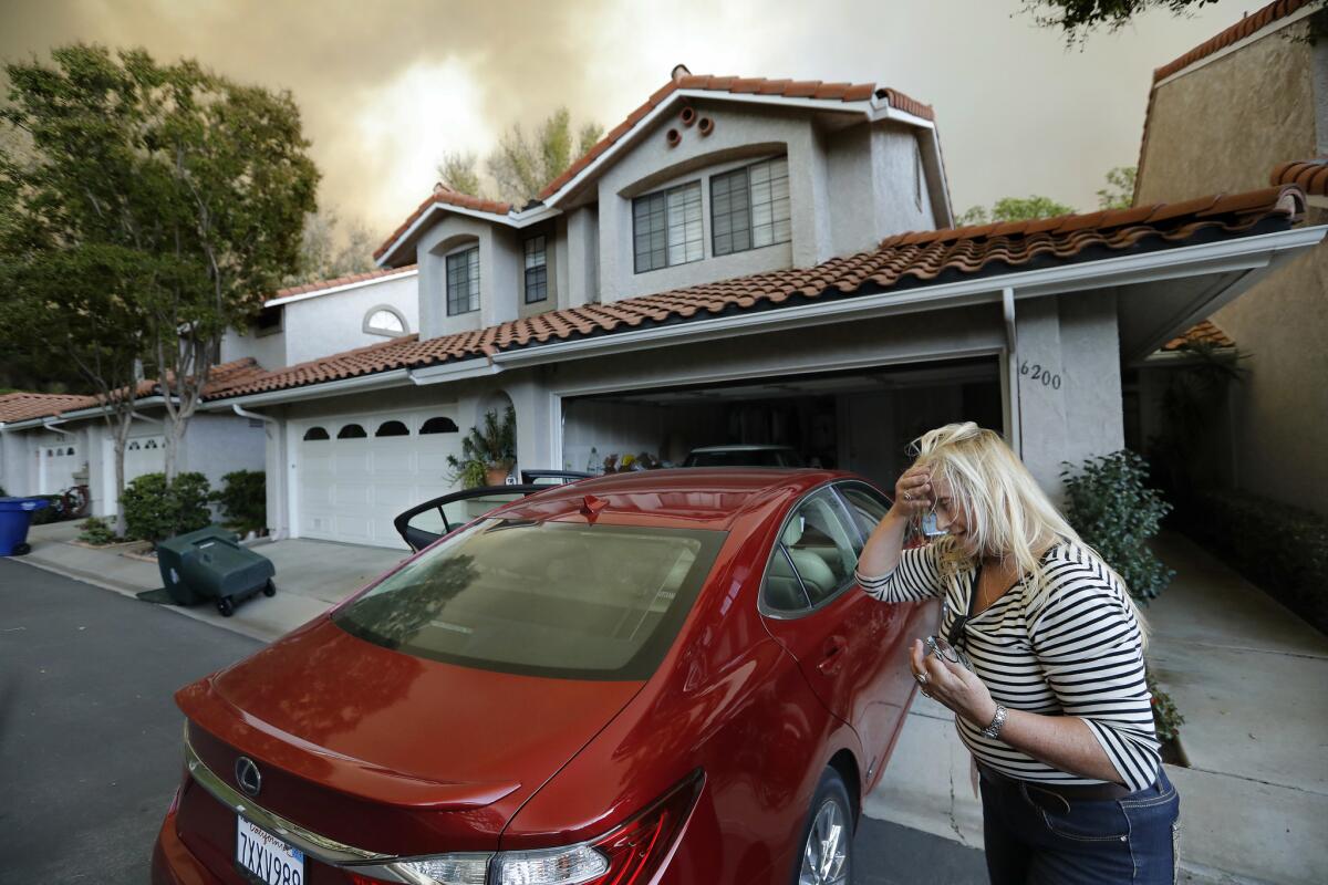 Carolina Heuel prepares to evacuate her Camarillo home after loading her two cats and a cockatiel into her car on Nov. 8.