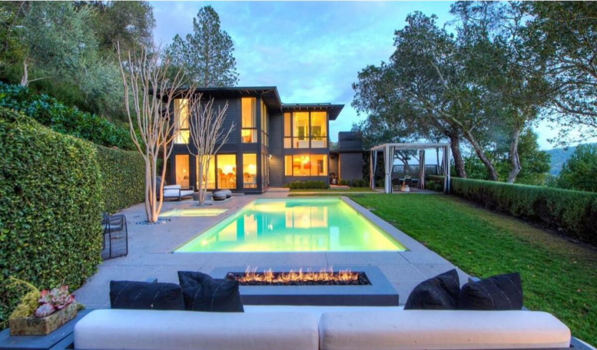 A pool and a modern-looking house.