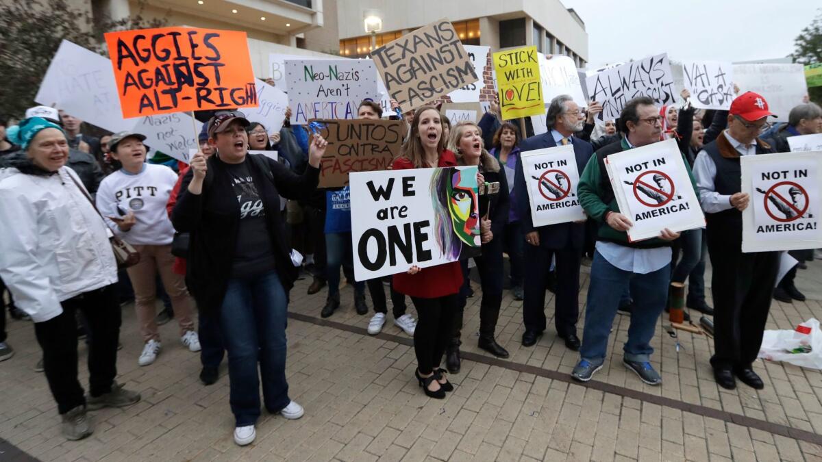 Demonstrators hold signs and chant outside the venue where Richard Spencer, who leads a movement that mixes racism, white nationalism and populism, is scheduled to speak at Texas A&M University in College Station, Texas on Dec. 6.