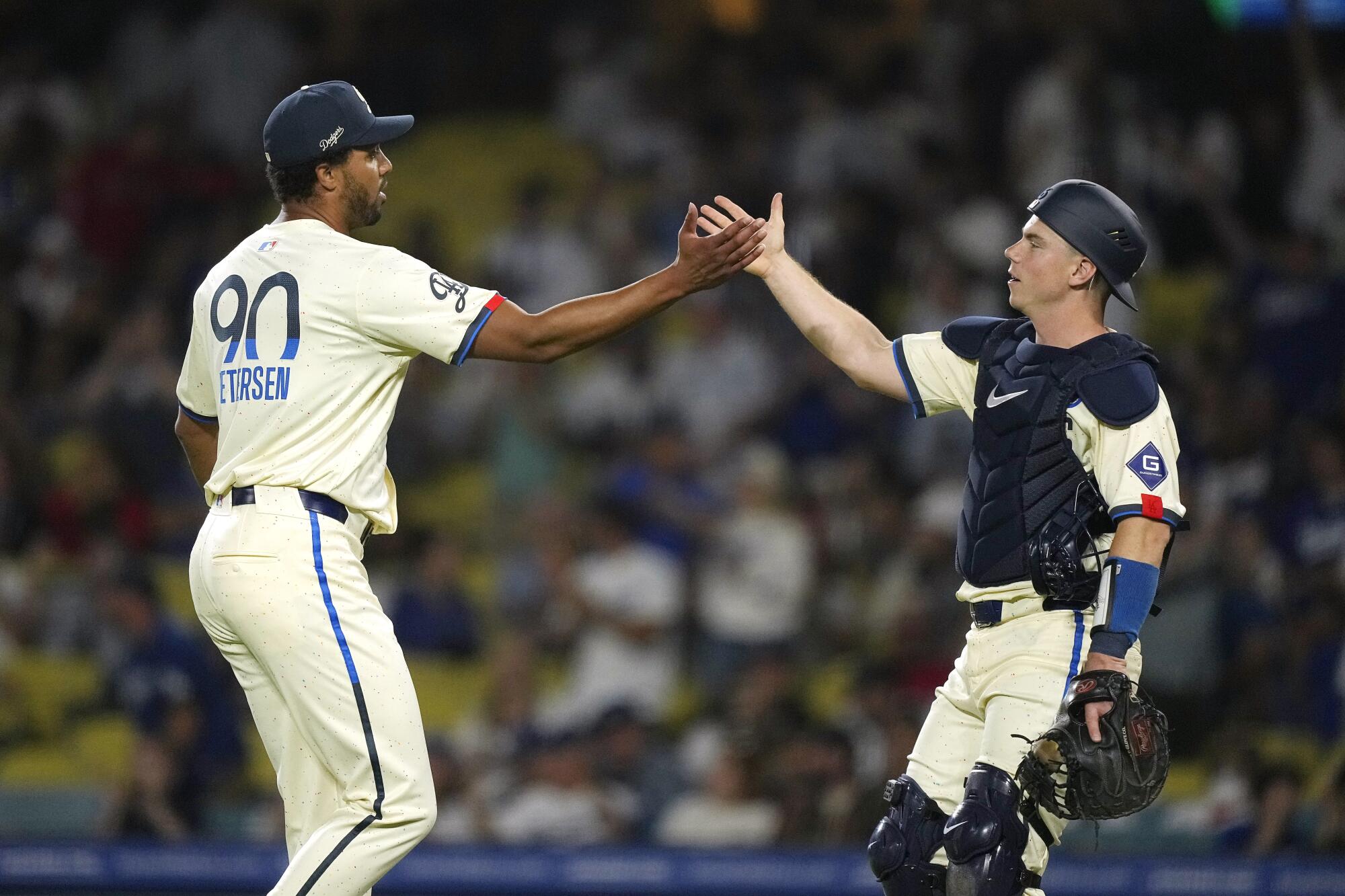 Dodgers relief pitcher Michael Petersen, left, and Will Smith congratulate each other after the Dodgers defeated the Angels.