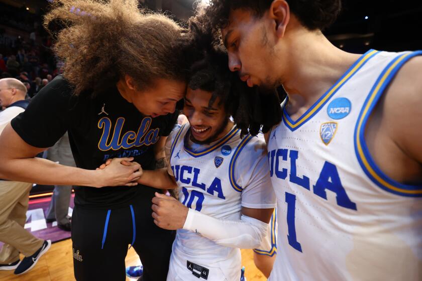 PORTLAND, OR - MARCH 17: Mac Etienne #12 of the UCLA Bruins celebrates with Tyger Campbell #10 and Jules Bernard #1 after defeating the Akron Zips during the first round of the 2022 NCAA Men's Basketball Tournament held at the Moda Center on March 17, 2022 in Portland, Oregon. (Photo by Jamie Schwaberow/NCAA Photos via Getty Images)