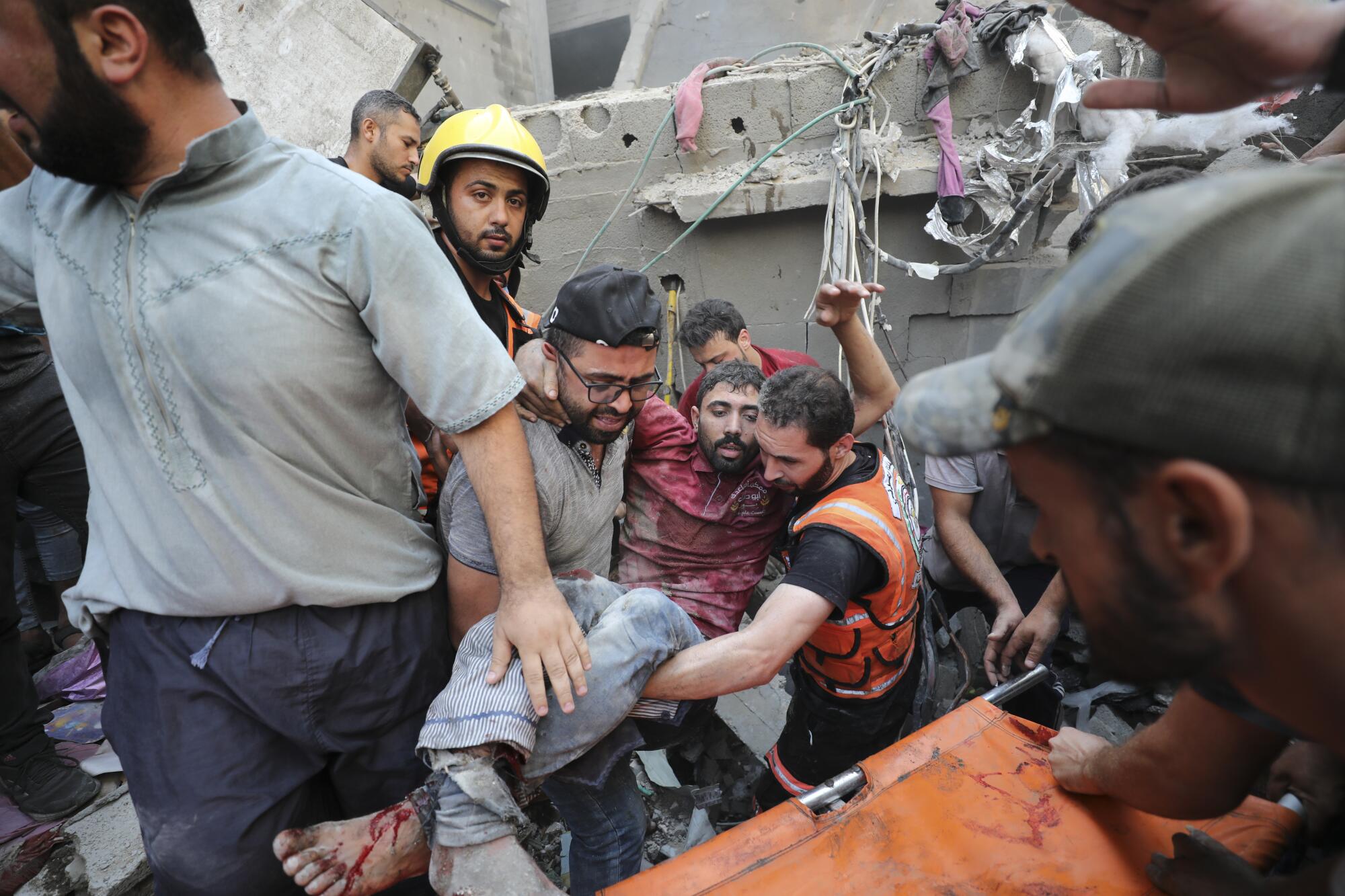 A survivor of the Israeli bombardment of Gaza being pulled from rubble