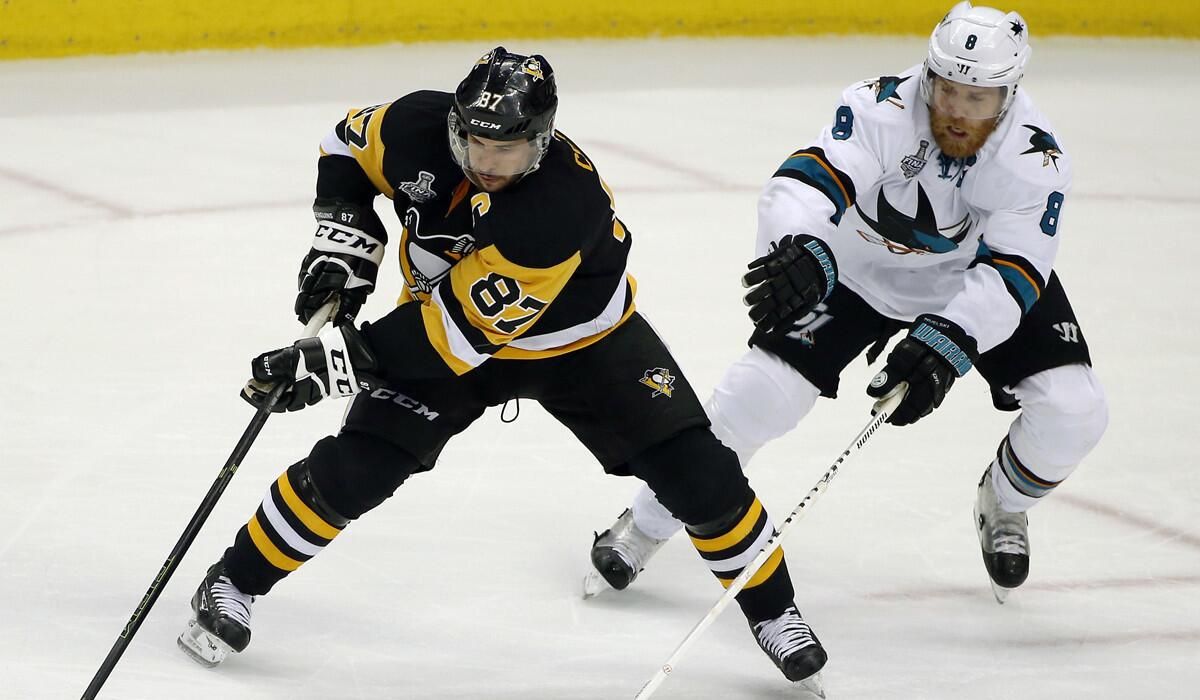 Pittsburgh Penguins' Sidney Crosby, left, moves the puck against San Jose Sharks' Joe Pavelski during the third period in Game 2 of the Stanley Cup Finals on Wednesday.