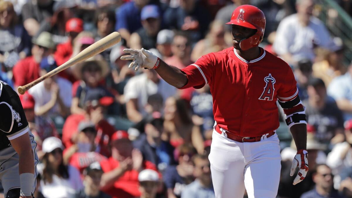The Angels' Justin Upton tosses aside his bat after walking against the Chicago White Sox in a spring training game on March 22 in Tempe, Ariz.