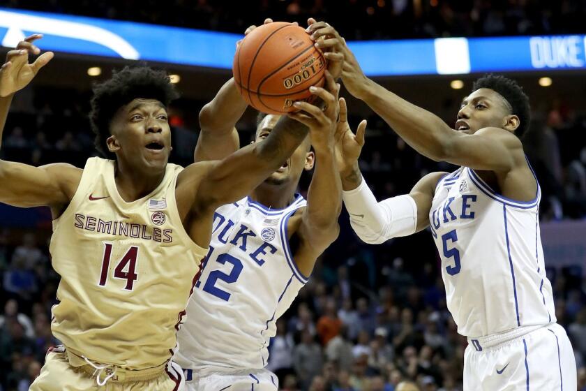 CHARLOTTE, NORTH CAROLINA - MARCH 16: Teammates Javin DeLaurier #12 and RJ Barrett #5 of the Duke Blue Devils battle for possession against Terance Mann #14 of the Florida State Seminoles during the championship game of the 2019 Men's ACC Basketball Tournament at Spectrum Center on March 16, 2019 in Charlotte, North Carolina. (Photo by Streeter Lecka/Getty Images) ** OUTS - ELSENT, FPG, CM - OUTS * NM, PH, VA if sourced by CT, LA or MoD **