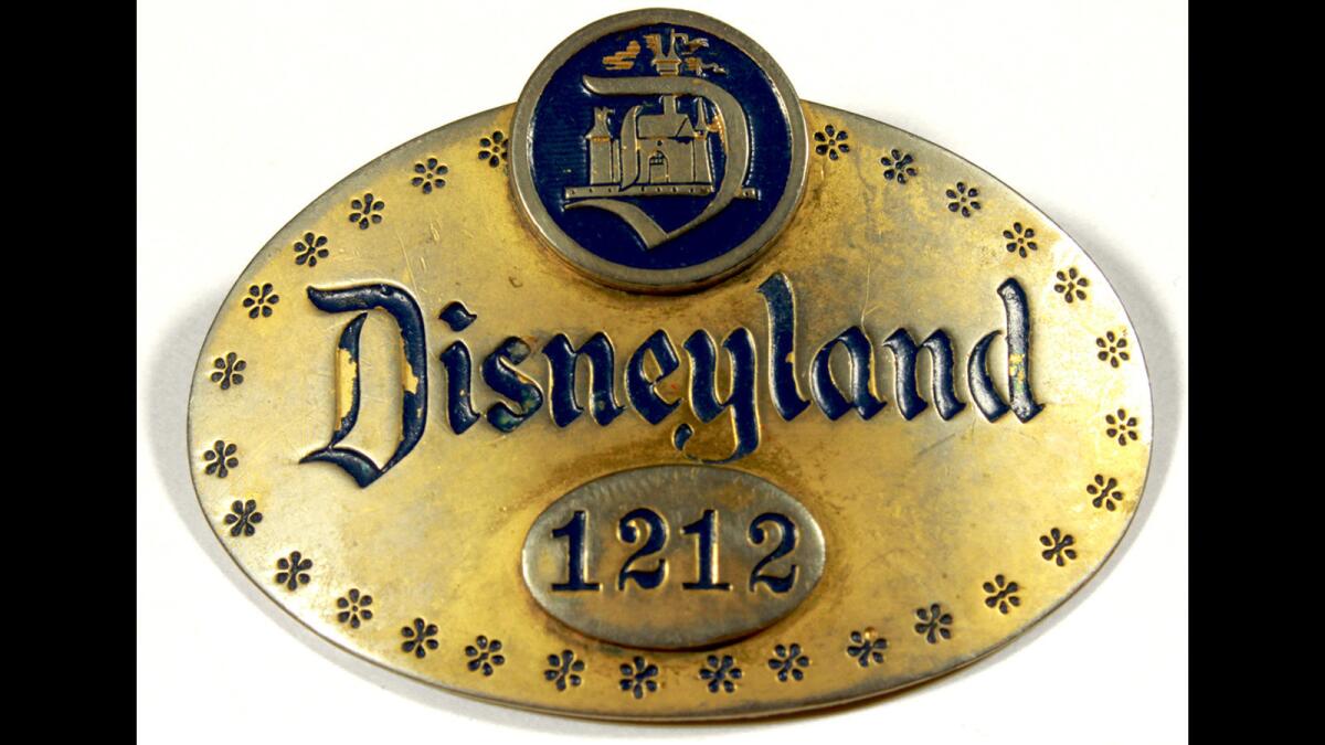 An original Disneyland cast member badge from opening day on July 17, 1955. Amid COVID-related headwinds, financial analysts will be paying close attention to a quarterly earnings call.