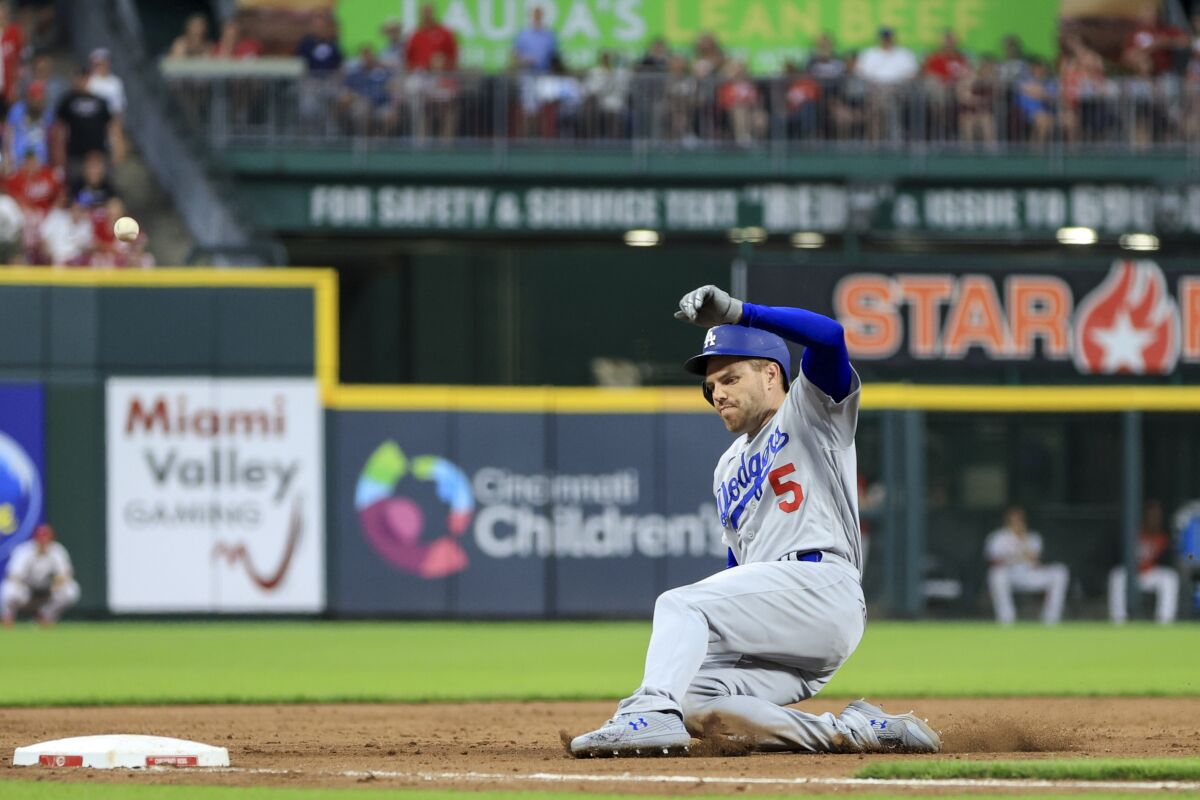 The Dodgers' Freddie Freeman slides into third on a triple.