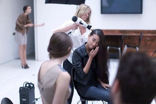 A model has her hair done before a fashion show for the Brooklyn designer Hayden-Harnett.