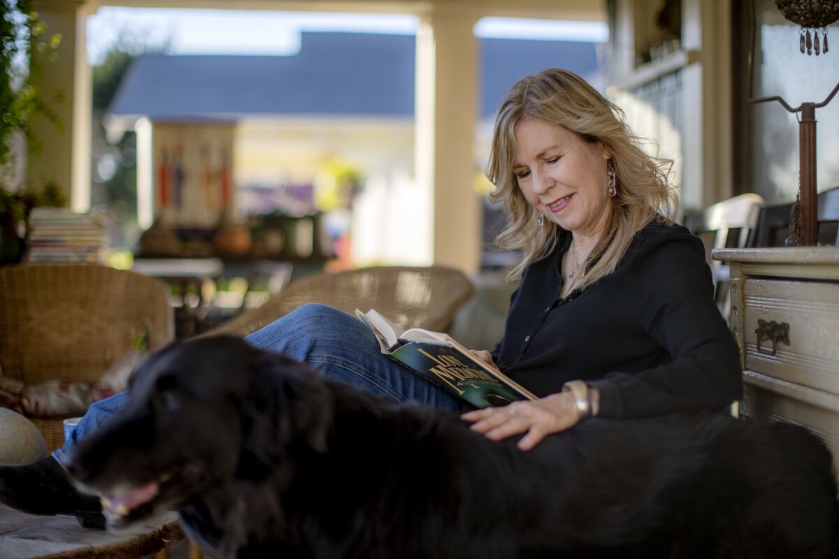Author Susan Straight sits on her front porch.