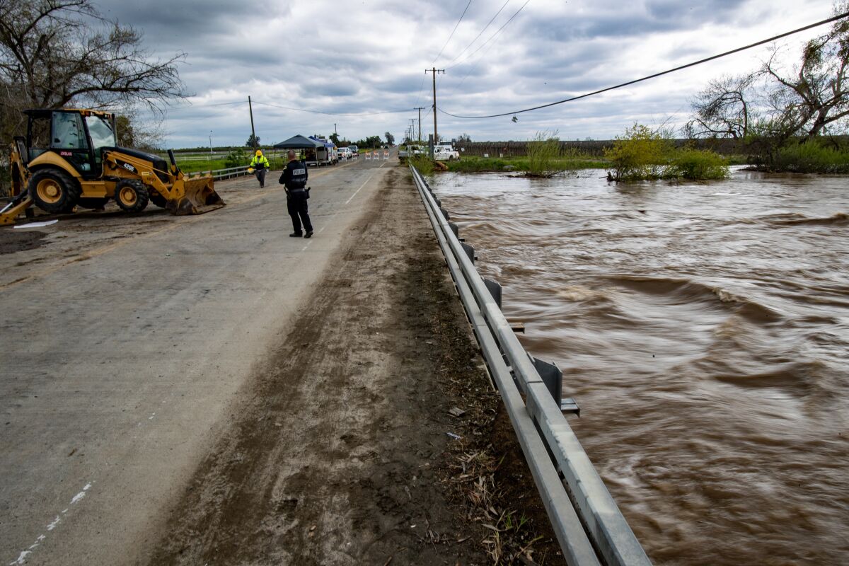 The Tule River's water level almost reaches the top of a bridge that carries Avenue 152 over it in Porterville, Calif.