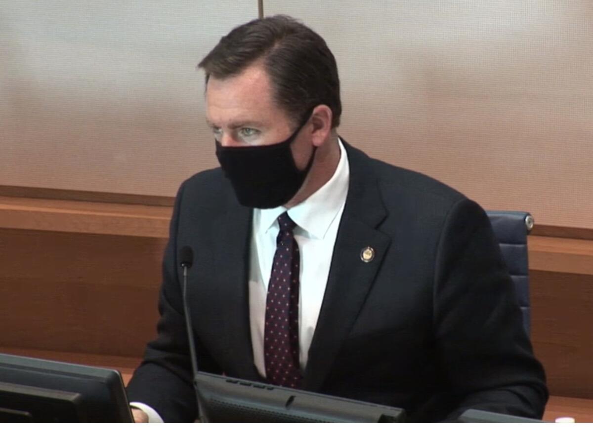 Newport Mayor Will O'Neill wears a face mask during a Newport Beach City Council meeting in April 2020.