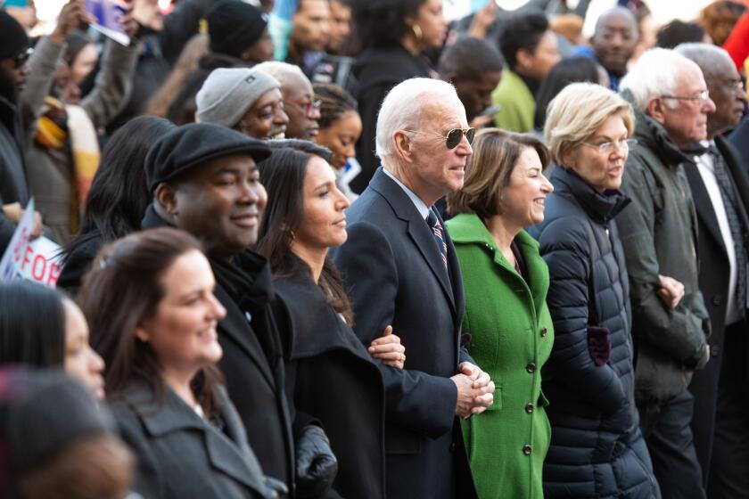 Democratic presidential candidates, former Vice President Joe Biden, center, Sen. Bernie Sanders (I-VT), right, Sen. Elizabeth Warren (D-MA) and Sen. Amy Klobuchar (D-MN) march on Washington Street during the King Day Dome March and Rally on January 20, 2020 in Columbia, South Carolina.