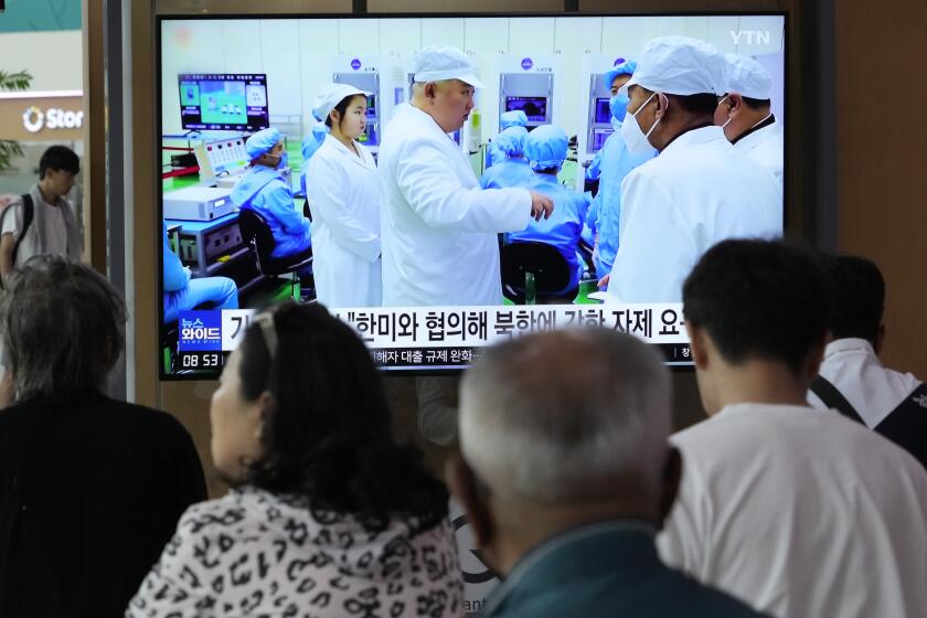 A TV screen shows a file image of North Korean leader Kim Jong Un, third from left, during a news program at the Seoul Railway Station in Seoul, South Korea, Monday, May 29, 2023. Japan's coast guard said North Korea has notified it that it plans to launch a satellite in coming days. (AP Photo/Ahn Young-joon)