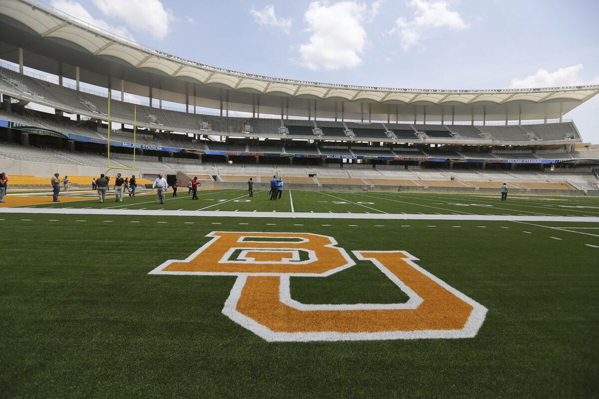 FILE - In this Aug. 18, 2014, file photo, the Baylor University logo is displayed on the football field at McLane Stadium in Waco, Texas. The NCAA infractions committee said Wednesday, Aug. 11, 2021, that its years-long investigation into the Baylor sexual assault scandal would result in four years probation and other sanctions, though the “unacceptable” behavior at the heart of the case did not violate NCAA rules. (AP Photo/Waco Tribune-Herald via AP, File)