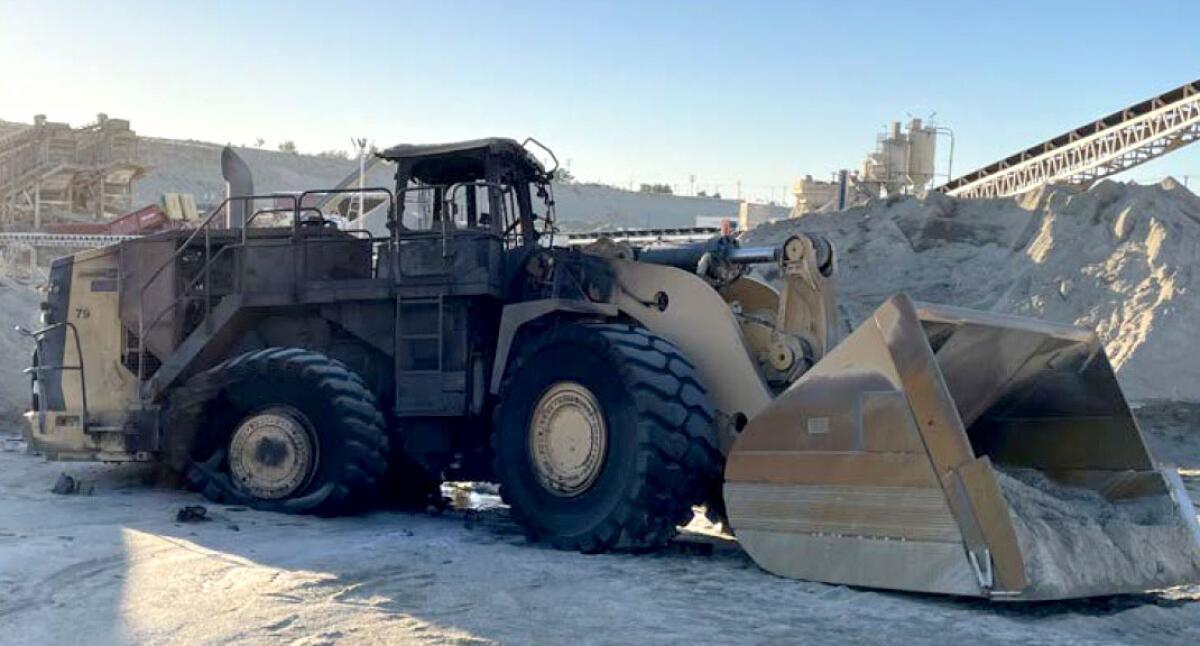 A construction vehicle with a damaged tire.