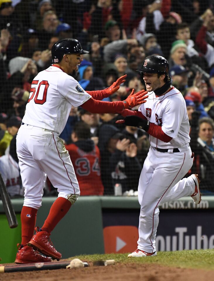 Red Sox's Mookie Betts and Andrew Benintendi celebrate after both scored on a J.D. Martinez single in the fifth inning.