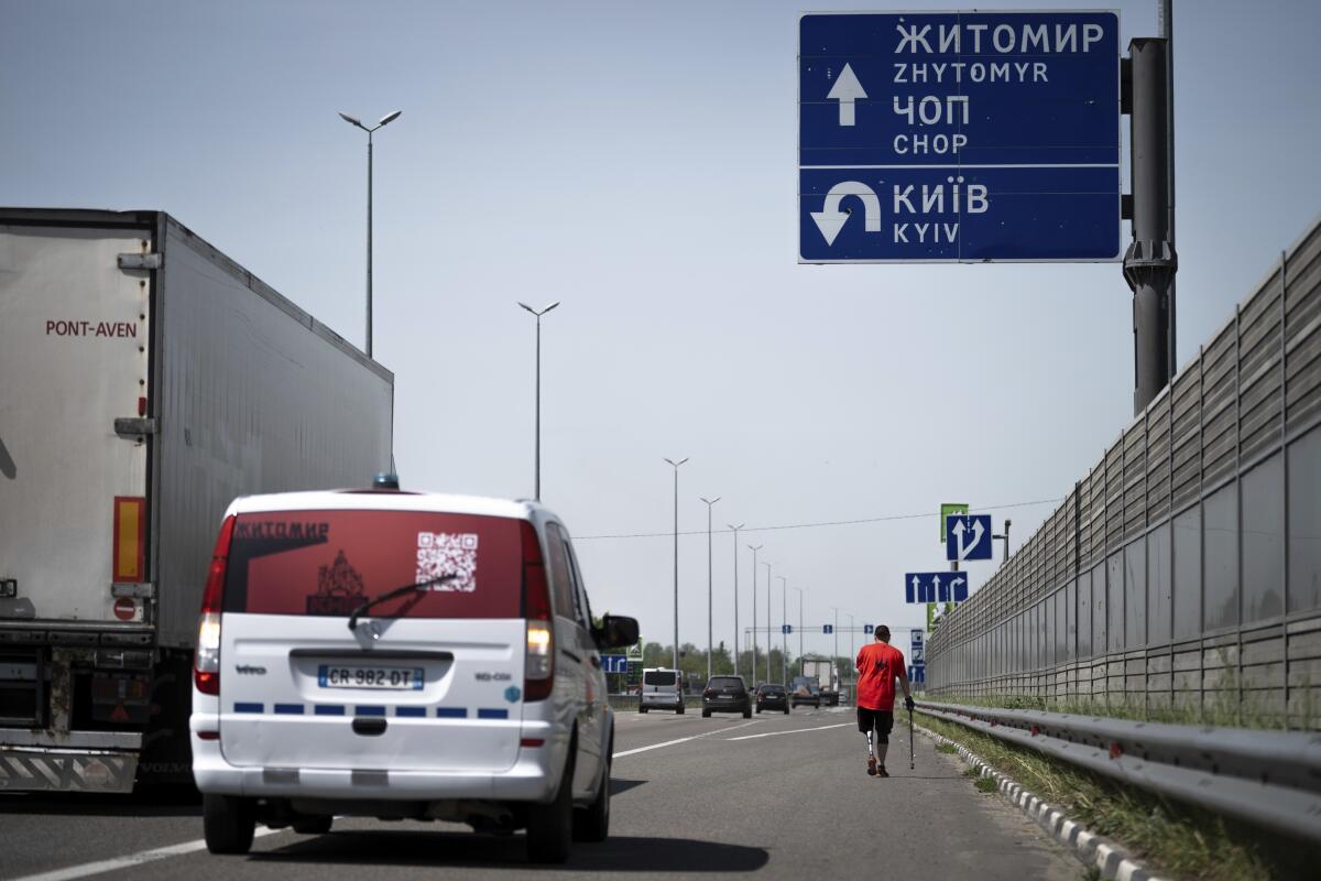 Serhii Khrapko, a Ukrainian war veteran, walks along a highway