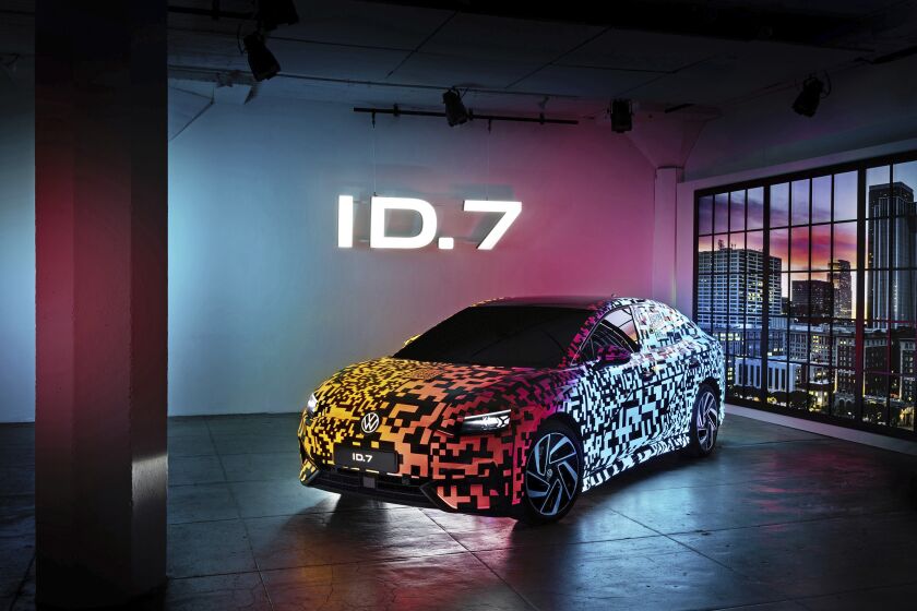 This photo provided by Volkswagen shows the Volkswagen ID.7, the brand's first electric sedan. It is shown here with a bespoke multicolor paint job that can be illuminated at night. (Courtesy of Volkswagen of America via AP)
