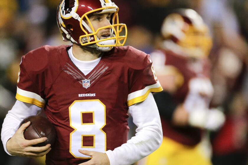 Washington Redskins quarterback Kirk Cousins looks up at the scoreboard after scoring a touchdown during the second half of an NFL wild card playoff football game against the Green Bay Packers Jan. 10.