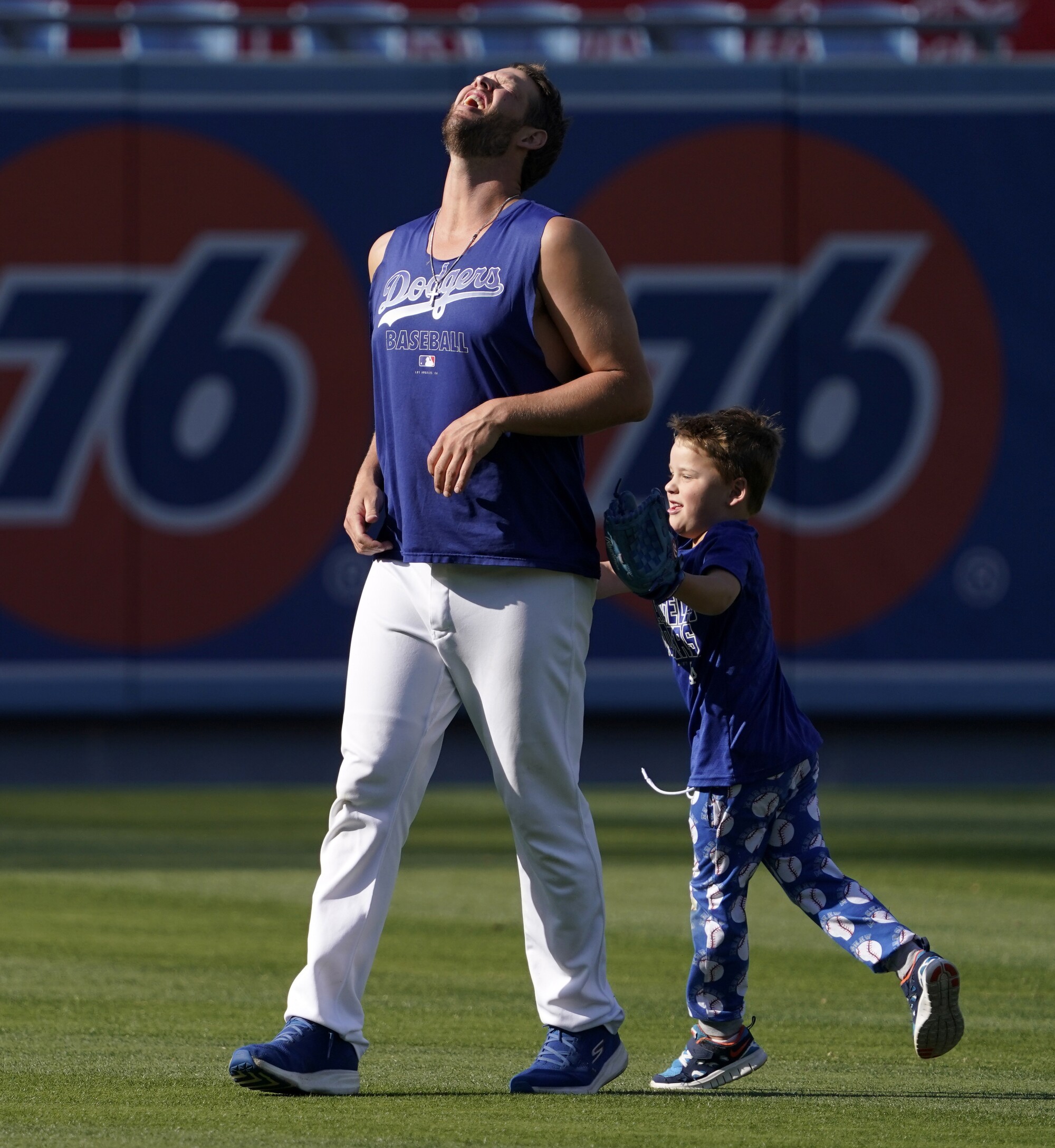 Los Angeles Dodgers pitcher Clayton Kershaw is chased by his son Charley before a game. 