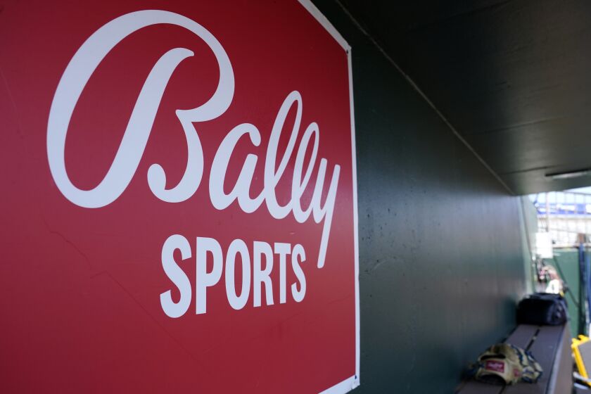 FILE - A Bally Sports logo is on a dugout wall during a spring training baseball game at Roger Dean Stadium, March 4, 2023, in Jupiter, Fla. Major League Baseball will take over broadcasts of San Diego Padres games beginning Wednesday, May 31. (AP Photo/Lynne Sladky, FIle)