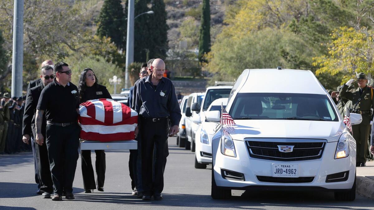 Pallbearers carry Border Patrol Agent Rogelio "Roger" Martinez into Our Lady of Guadalupe Church in El Paso, Texas, for a funeral Mass on Nov. 25.