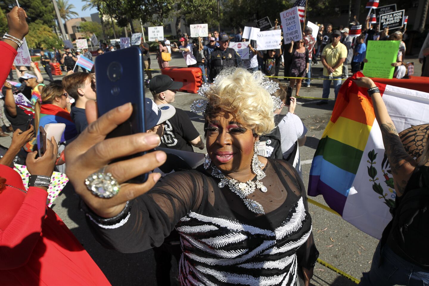 Gigi Masters goes live on FaceBook while standing with supporters of the Drag Queen Story Hour at the Chula Vista Public Library, Civic Center Branch, on Tuesday, September 10, 2019 in Chula Vista, California.