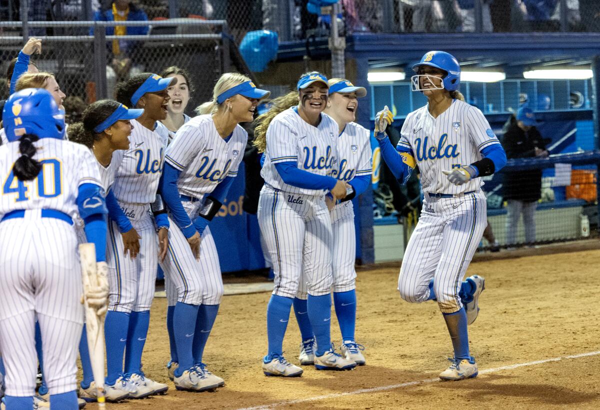 UCLA shortstop Maya Brady celebrates with teammates after hitting her second home run.