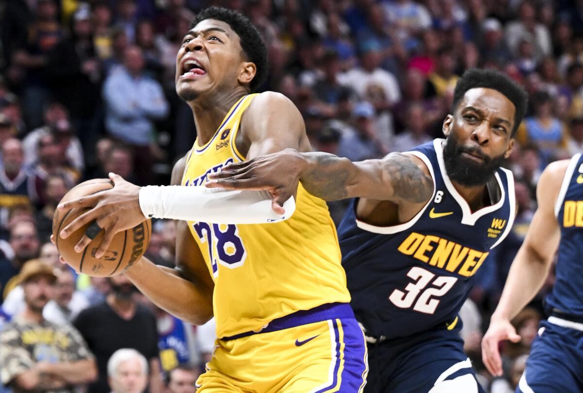 Nuggets forward Jeff Green, right, reaches around Lakers forward Rui Hachimura to commit a foul.