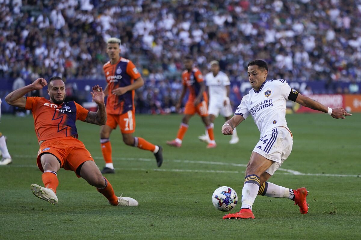 The Galaxy's Javier "Chicharito" Hernandez looks to shoot under pressure from NYCFC's Maxime Chanot 