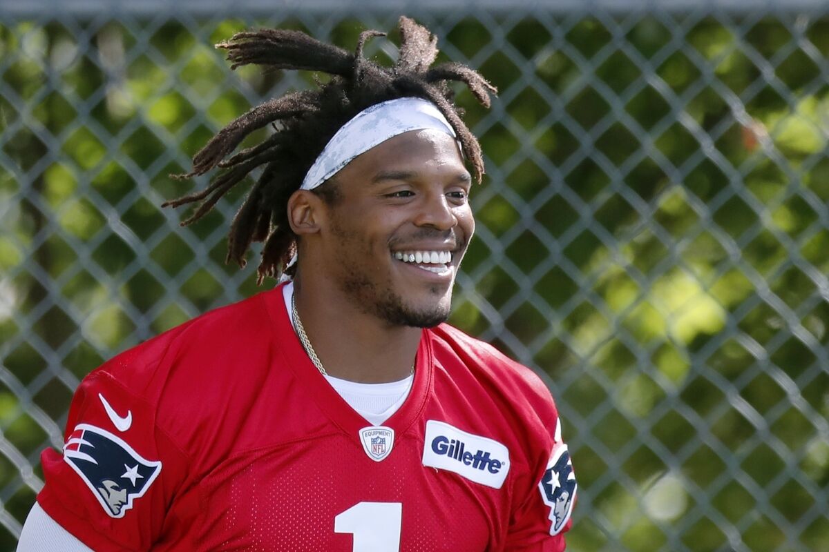New England Patriots quarterback Cam Newton smiles during practice.