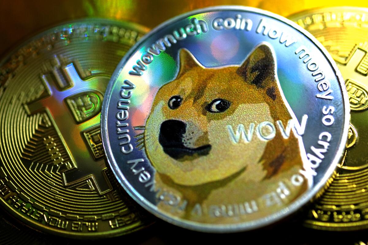 Illustration of tokens representing digital cryptocurrencies Dogecoin and Bitcoin