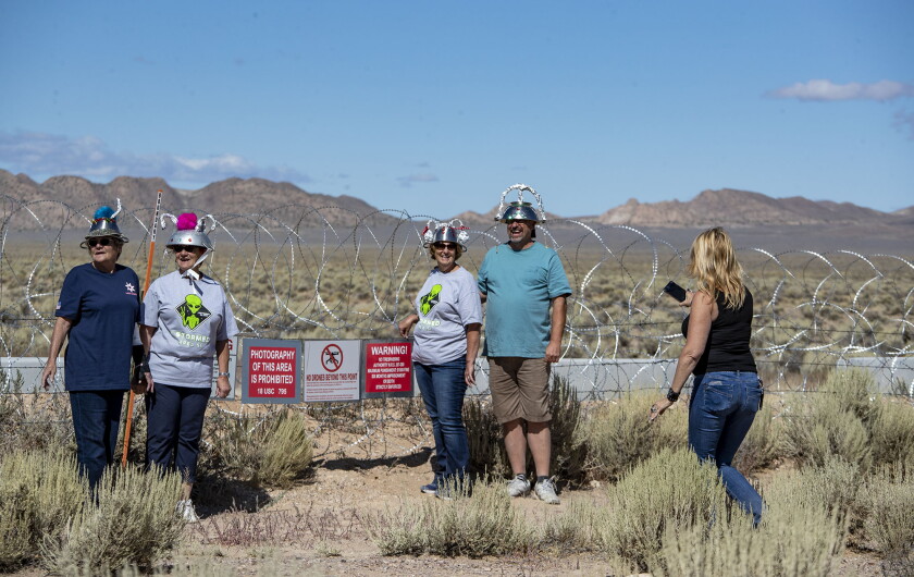 people wearing foil hats pose for a photo