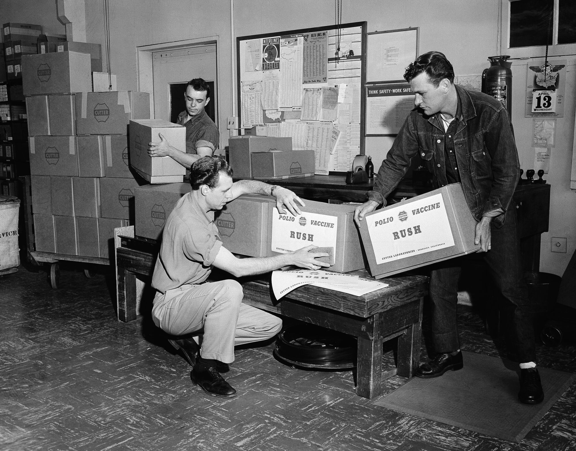 At Cutter Laboratories in Berkeley, Calif., workmen label the priority packages of Salk polio vaccine.