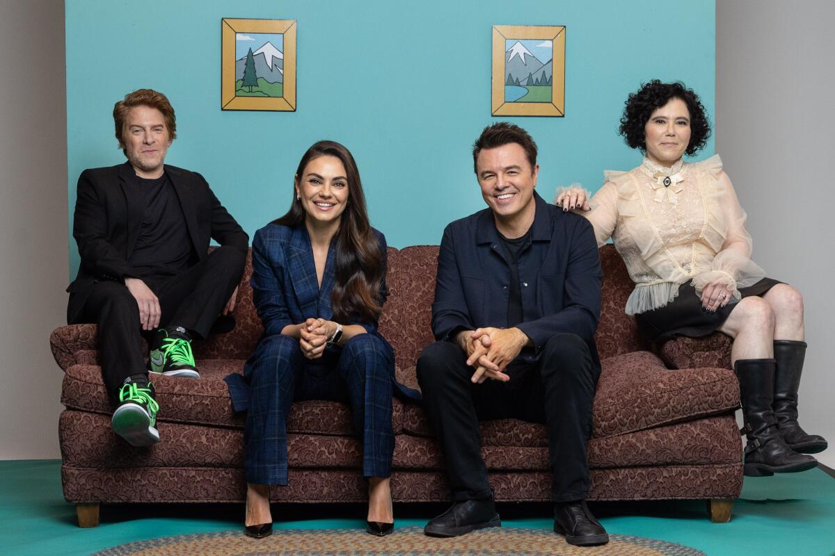 Four actors pose on a couch modeled on the animated "Family Guy" set.