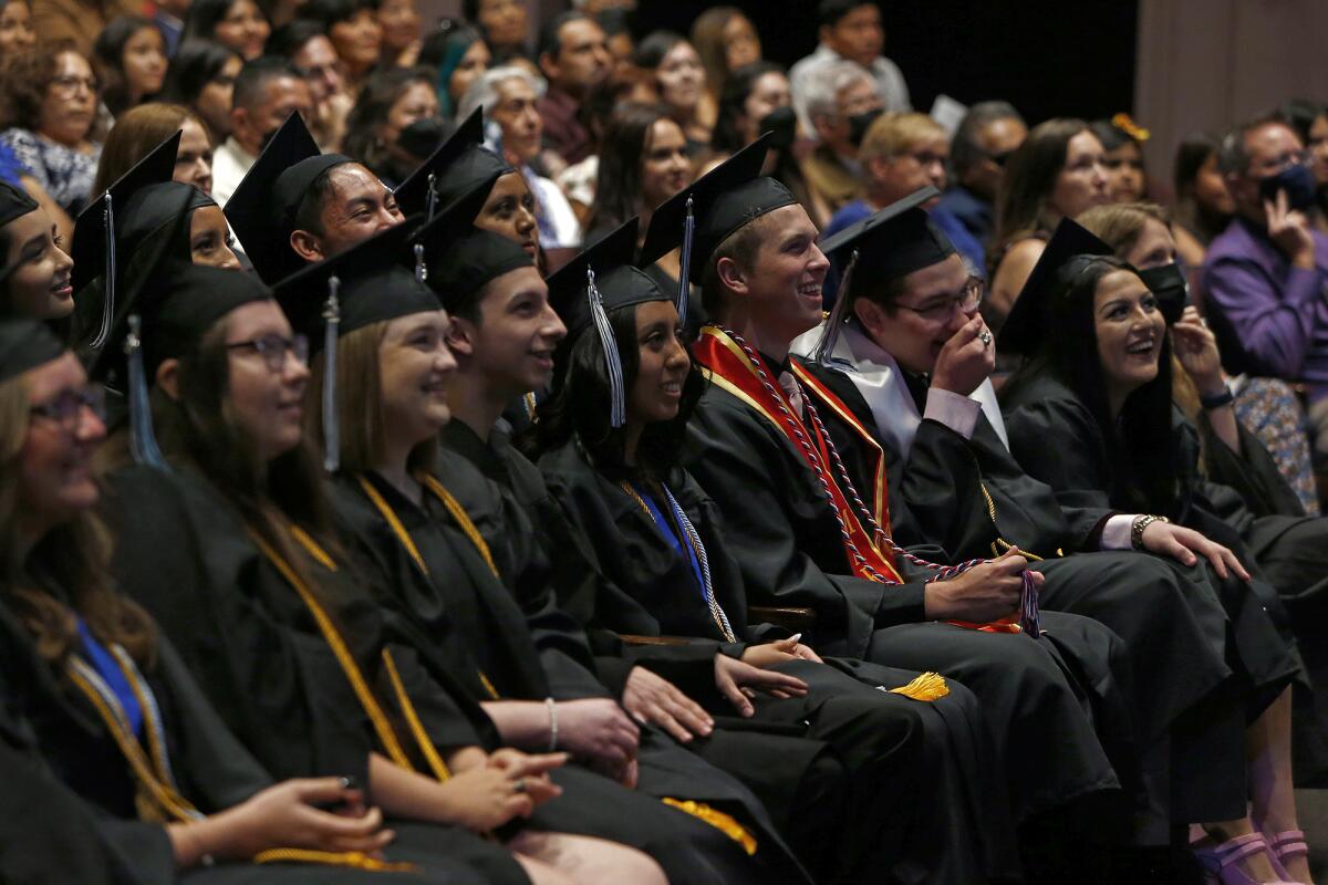 Seniors laugh at a slideshow presentation Thursday at Early College High School's graduation ceremony, June 2, 2022