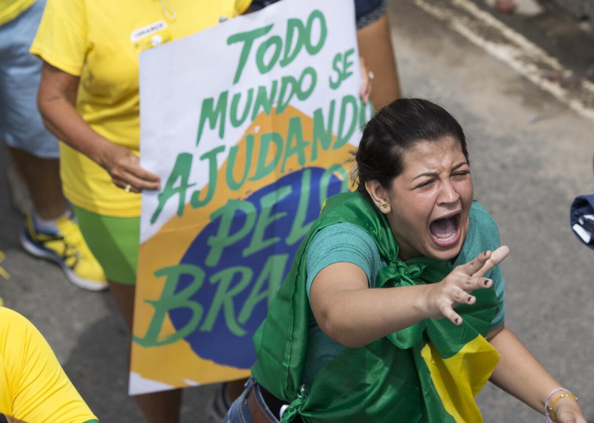 A demonstrator shouts slogans against Brazilian President Dilma Rousseff during a protest at Rio de Janeiro's Copacabana beach.